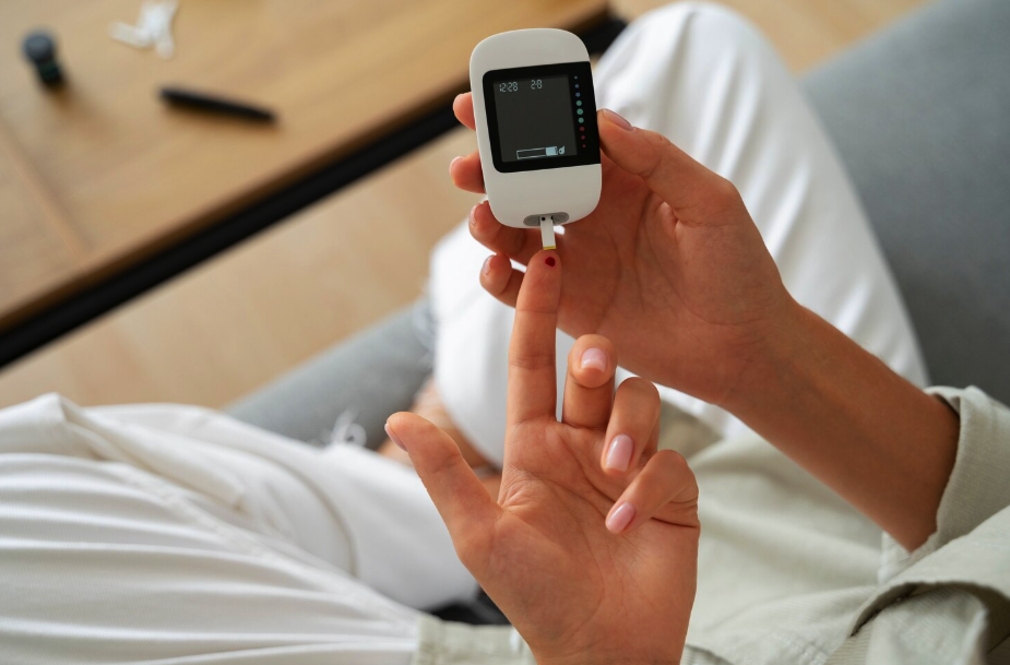 Close-up of a person checking their blood glucose level with a glucose meter