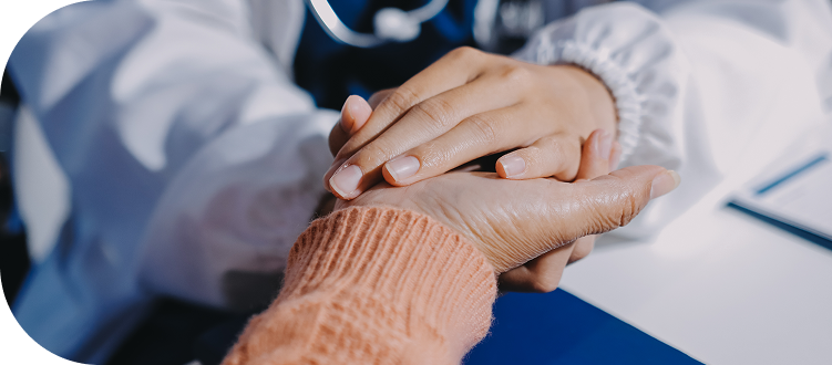 Doctor gently holding a patient's hand