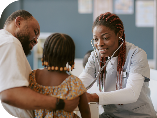 Doctor examining a young girl with a stethoscope while her father comforts her