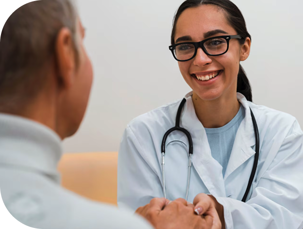 Smiling doctor in a white coat with a stethoscope shaking hands with a patient