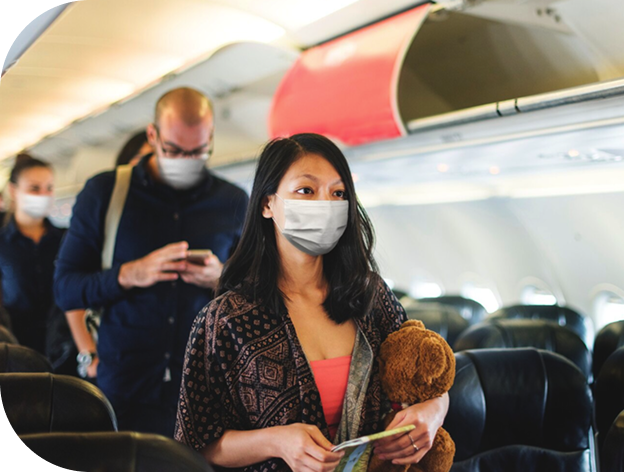 Travelers wearing masks at the airport, representing travel medicine and vaccine services at RightCare Family Medicine in Raleigh, NC