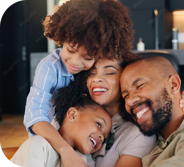 Happy family of four embracing and laughing together at home